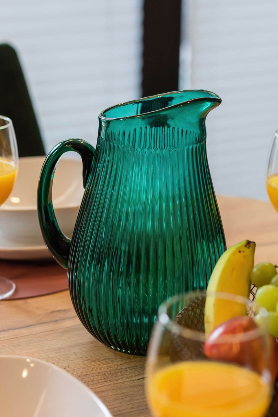 A decorative green vase and glasses, adding elegance to the table setting.


