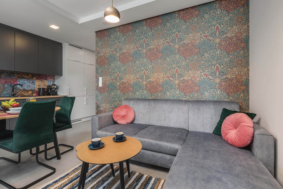 A cozy corner of the living area, featuring a decorative wall and comfortable seating with soft cushions.

