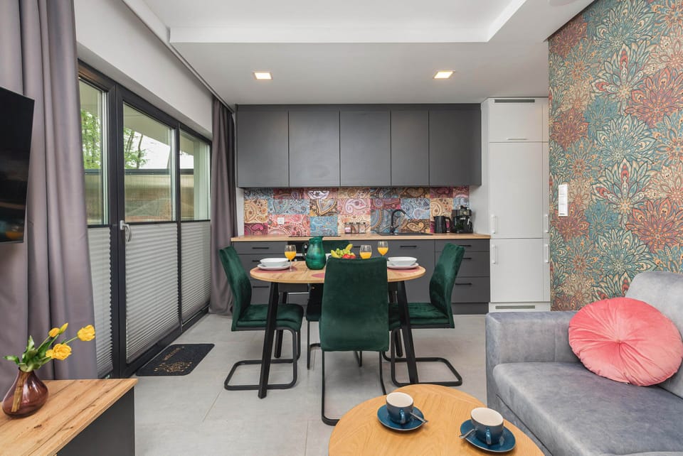 A well-designed open-plan layout, integrating a colorful kitchen and dining area.

