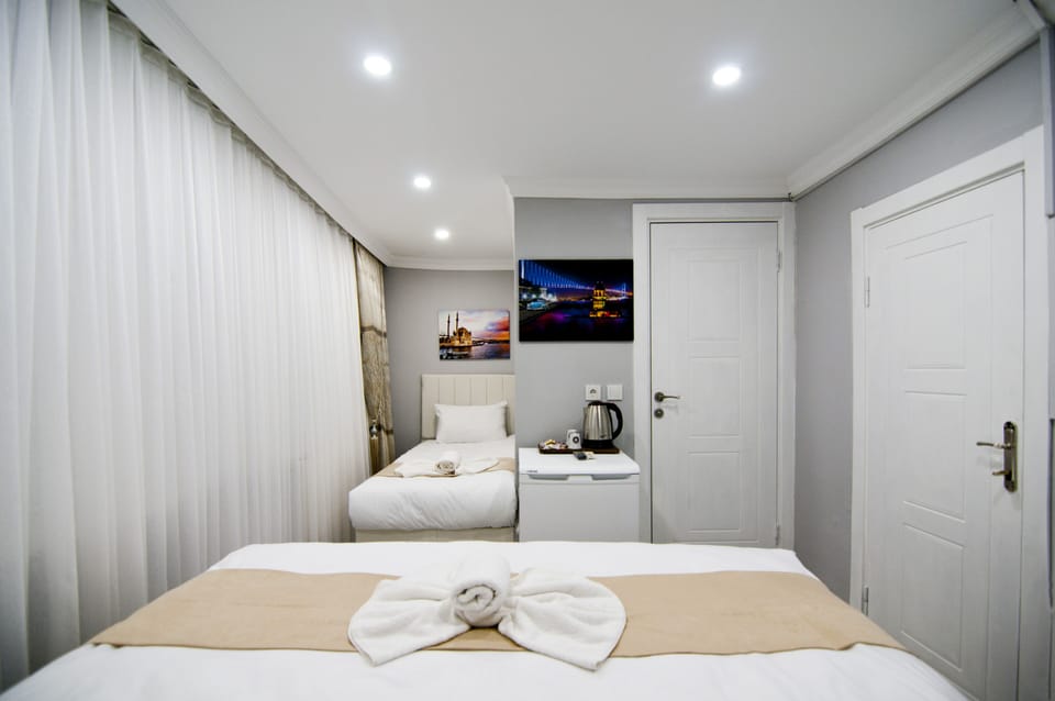 Standard Triple Room | Minibar, iron/ironing board, free WiFi, bed sheets