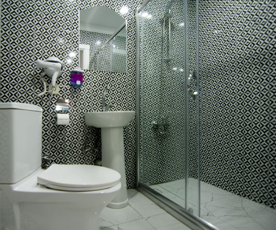 Shower, hair dryer, slippers, towels