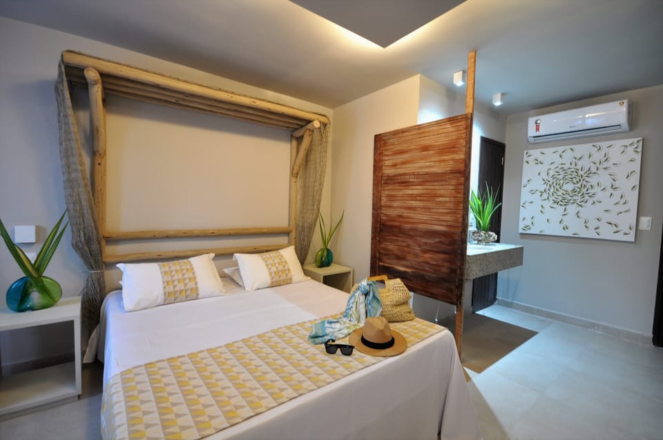 Deluxe Triple Room | Minibar, in-room safe, individually decorated, desk