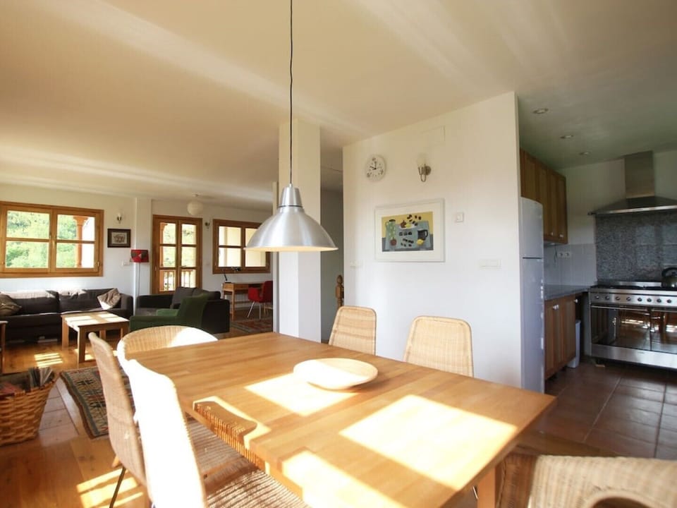 Dining area with table for 6. Open plan showing view to kitchen and living area.