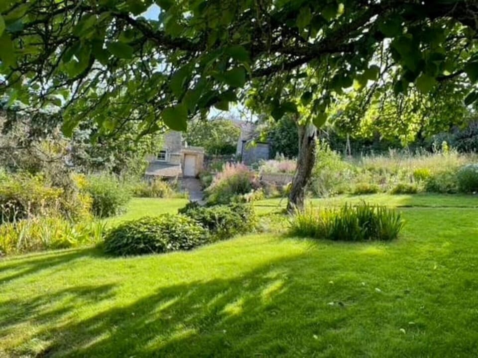 English country garden surrounds the front of the cottage 