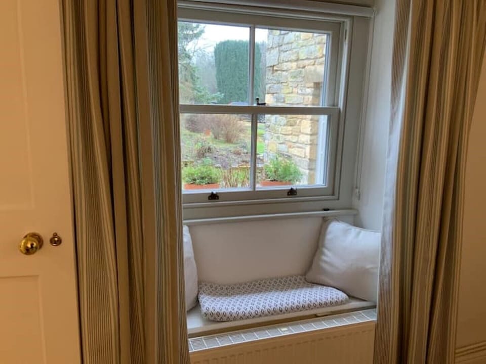 Beautiful window seat in the living room has views of the garden beyond