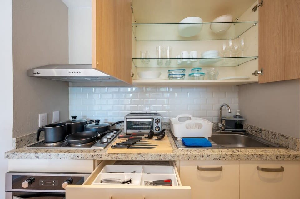 Fully equipped kitchen with appliances and utensils