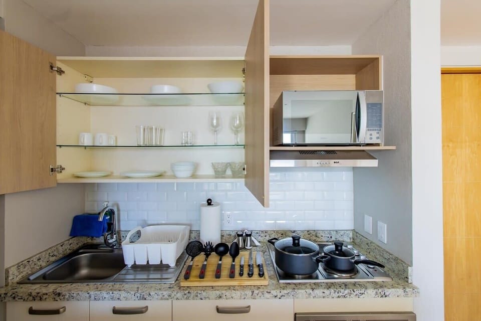 Fully equipped kitchen with appliances and utensils