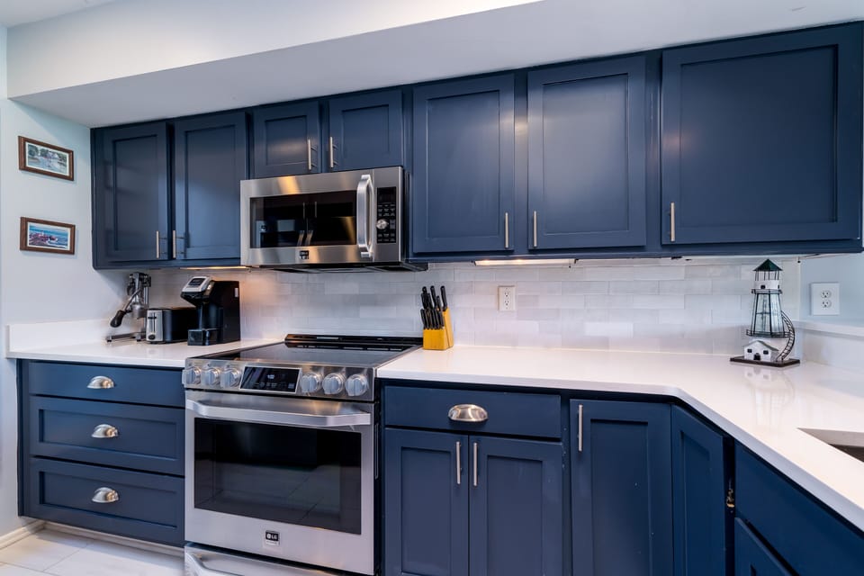 This gorgeous kitchen has custom cabinets, granite counters and subway tiled walls.