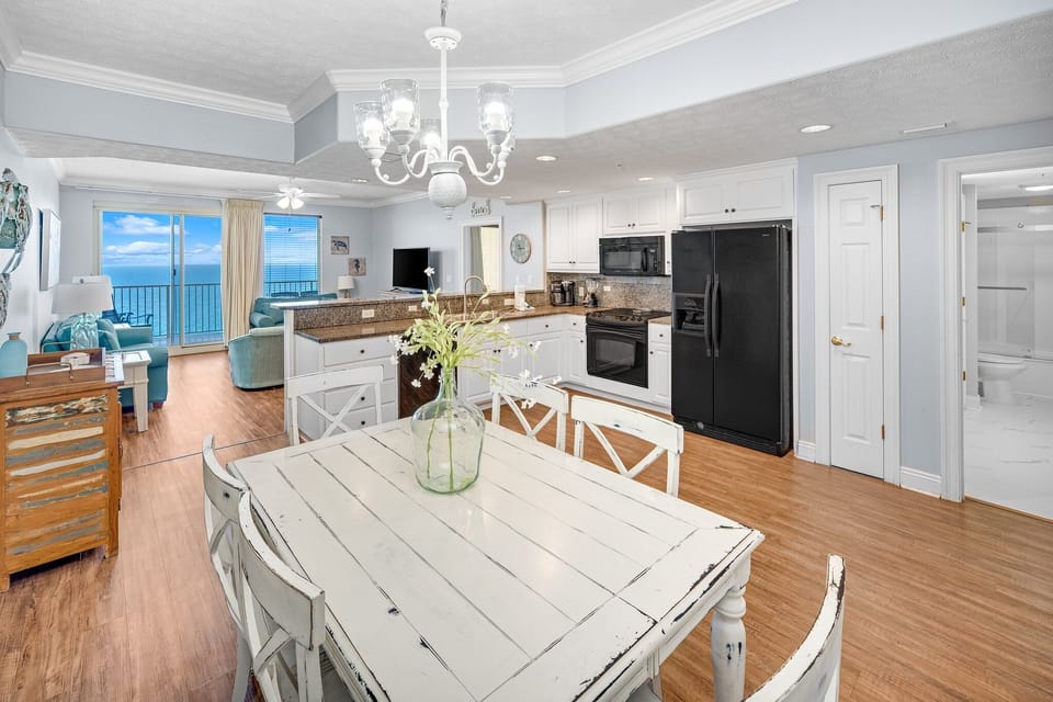 Open-concept kitchen and dining area with ocean views and coastal decor.