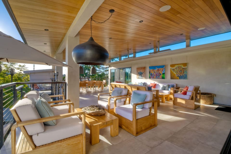 Private outdoor patio, comfortable couch seating for ten with 2 ten foot custom made couches and a 10 foot custom made teak table