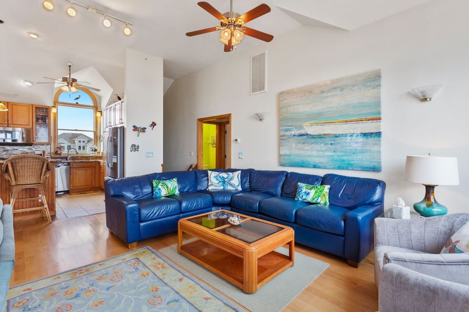 Relax in the beautiful Main Living Area with access to the Oceanfront Furnished Sun Deck. (Note: Fireplace is not for guest use)