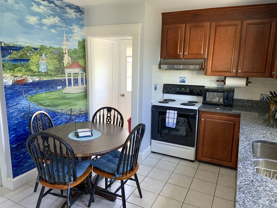 Kitchen viewed from den. Newport themed mural by local artist.