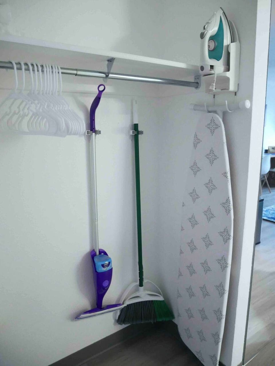 Cleaning essentials along with iron and ironing board.