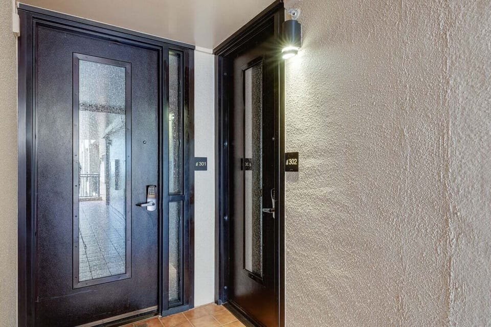 Welcoming entry featuring a modern door with glass panels and secure access for peace of mind
