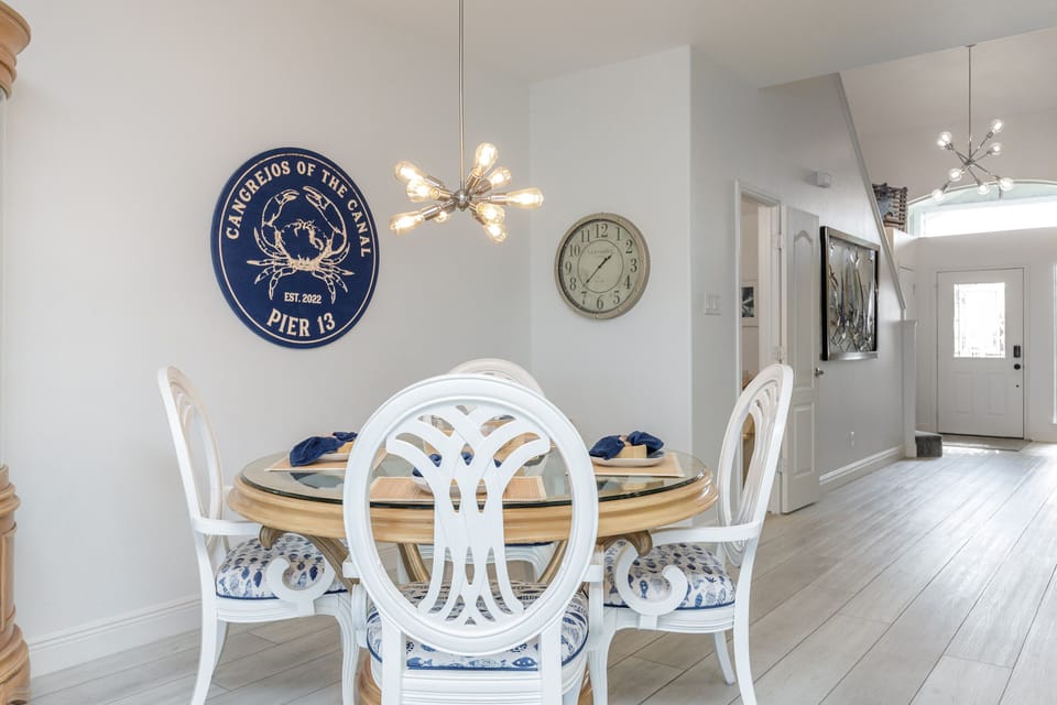 Your elegant dining space features coastal charm with stylish seating and warm lighting for memorable meals together.