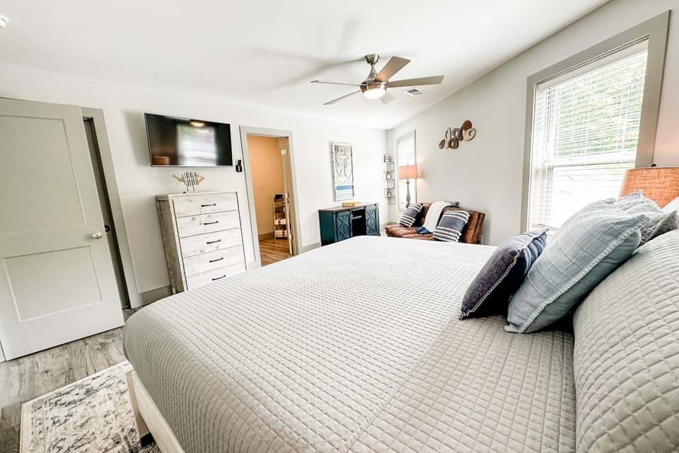 Guest bedroom with king size bed and smart tv.