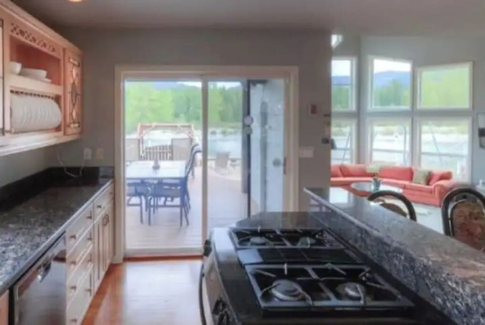 Well stoked kitchen.  Outside dining in the background with river flowing by