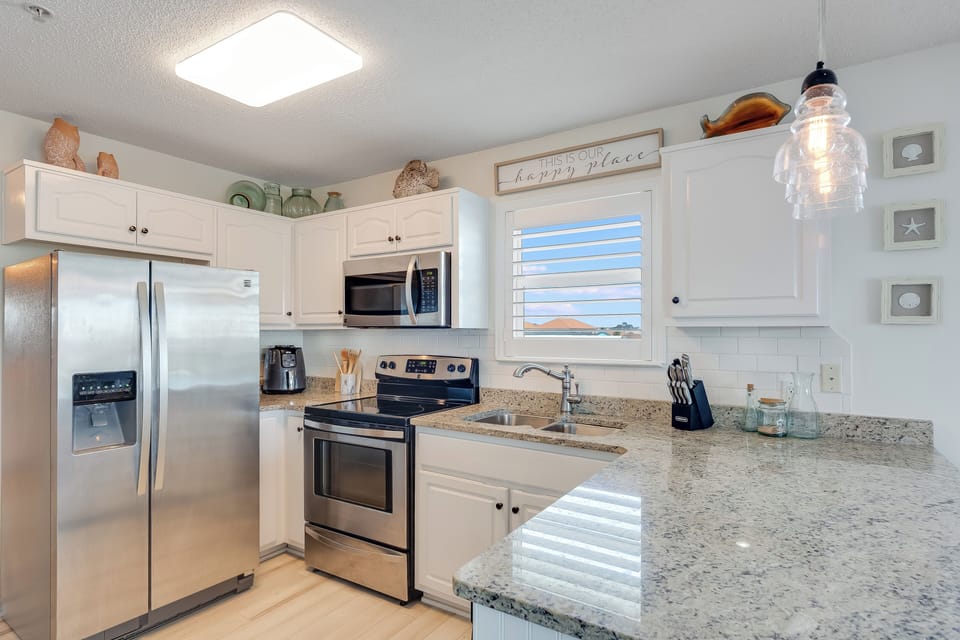 Spacious and neat, this kitchen offers you all the necessities for quick meals.