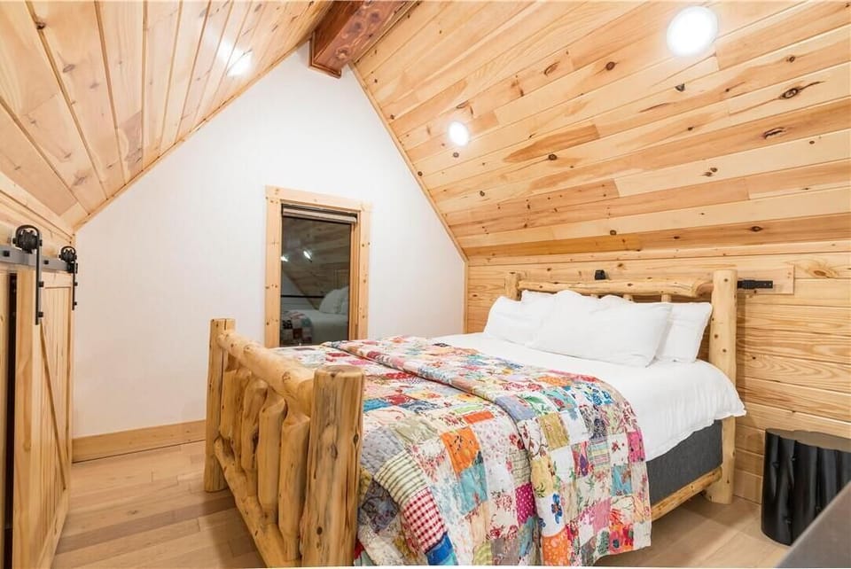 Queen sized bed in the loft bedroom of the ground level house