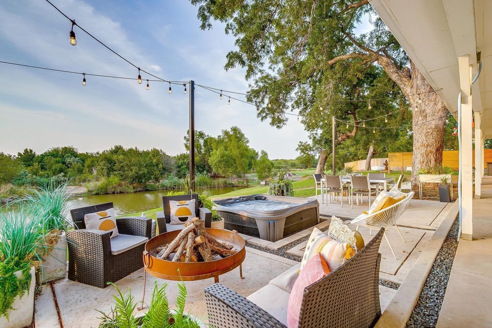 Outdoor living area with fire pit and hot tub at The Blanc Lake Granbury
