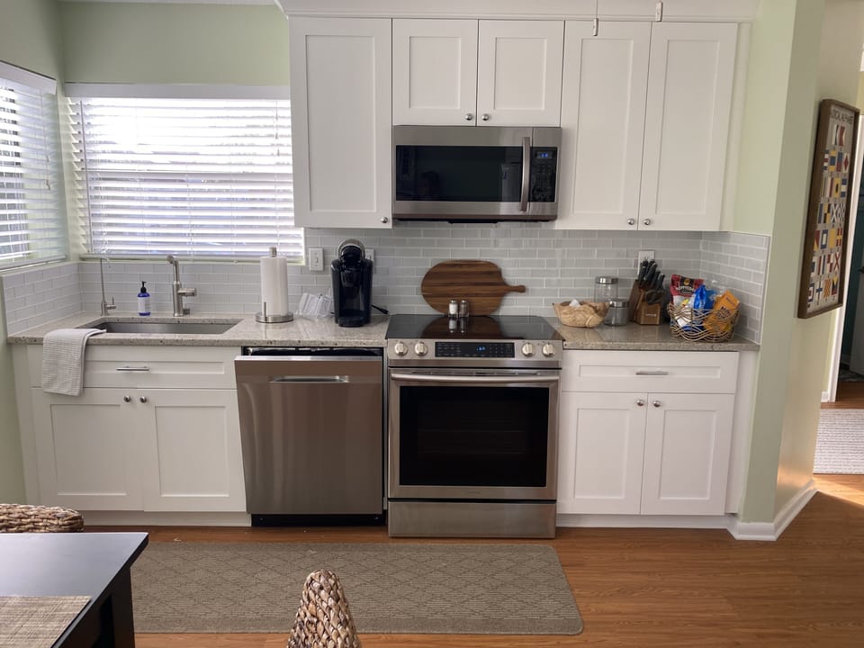 A very spacious kitchen with beautiful cabinetry and granite counter tops. 