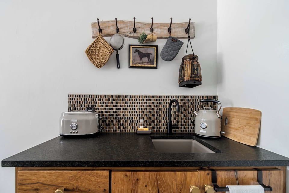 Kitchenette with coffee setup, microwave, mini fridge, and essentials