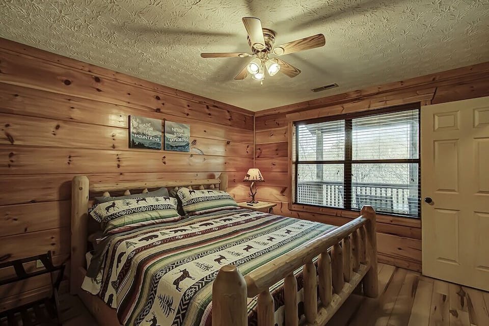 Main level bedroom with King sized, attached full bath, and bed and 43" smart TV