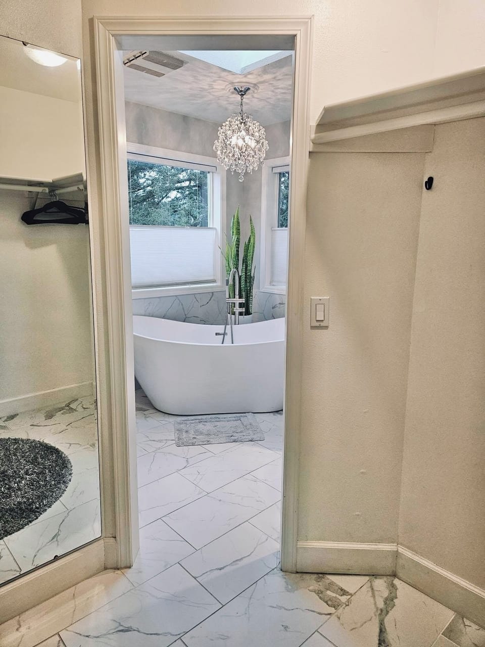 Walk in closet looking in to ensuite bathroom