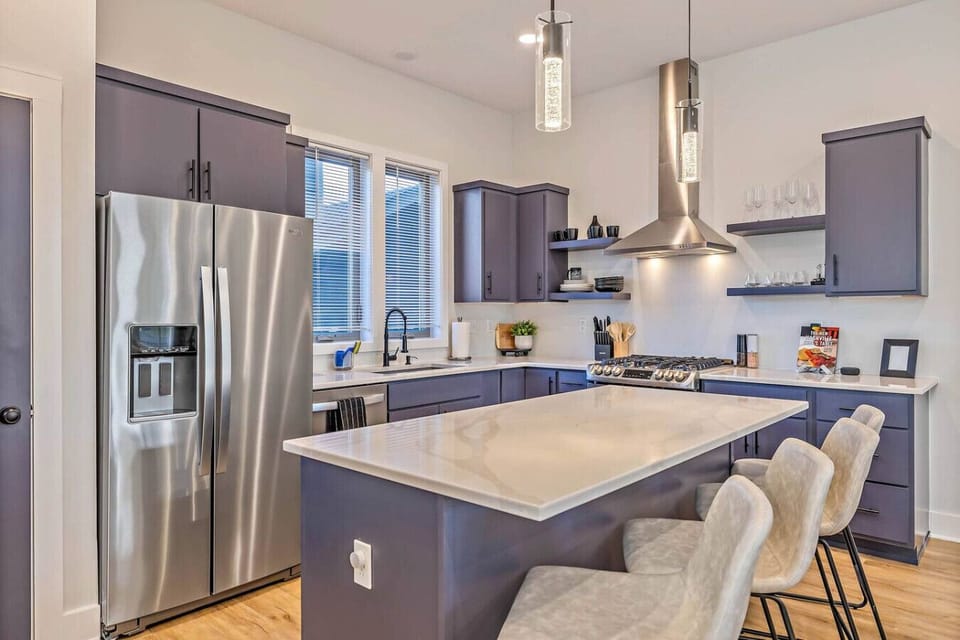 Fully equipped kitchen with dishware and dining seating for 10