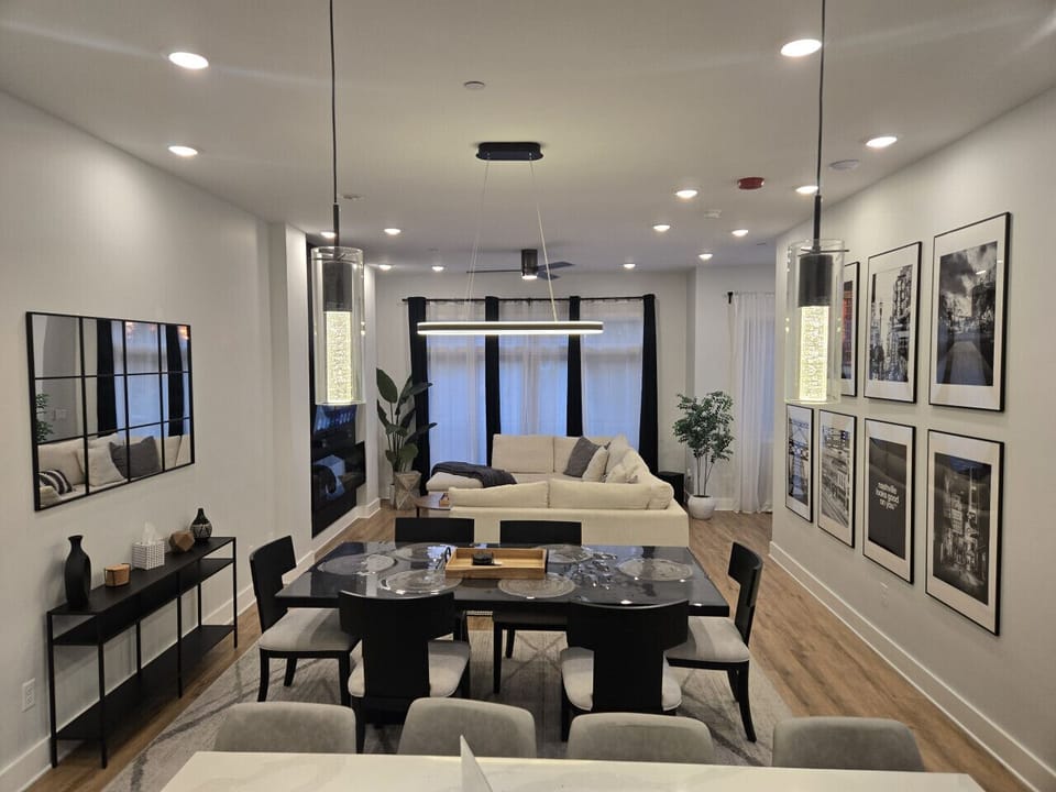 Living room boasts a 65` Smart TV, Hi-fi soundbar with sub, electric fireplace, monster sofa couch with huge pull-out sleeper