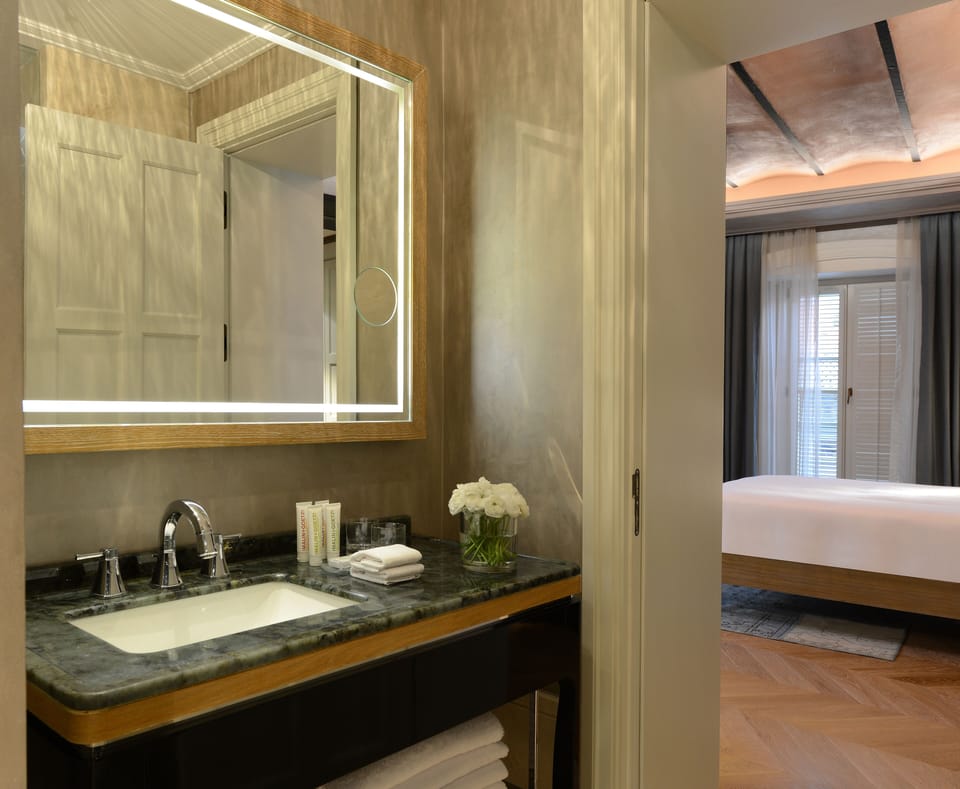 Shower, designer toiletries, hair dryer, slippers