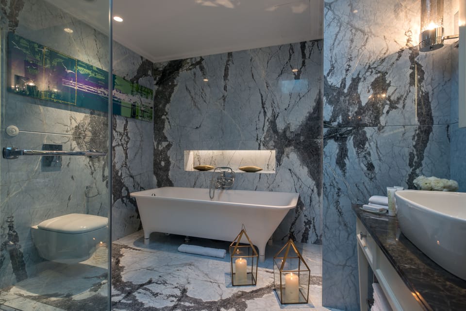 Shower, designer toiletries, hair dryer, slippers