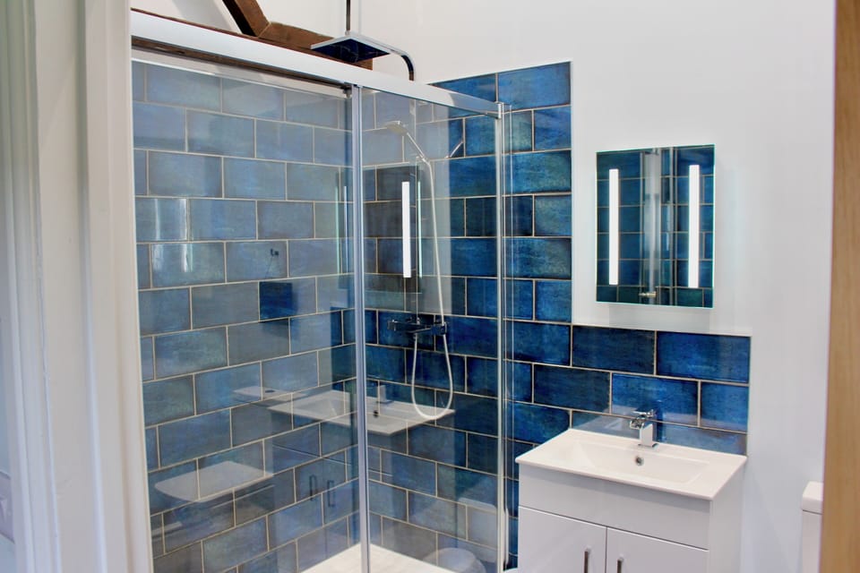 Main bathroom with large shower cubicle, heated towel rail