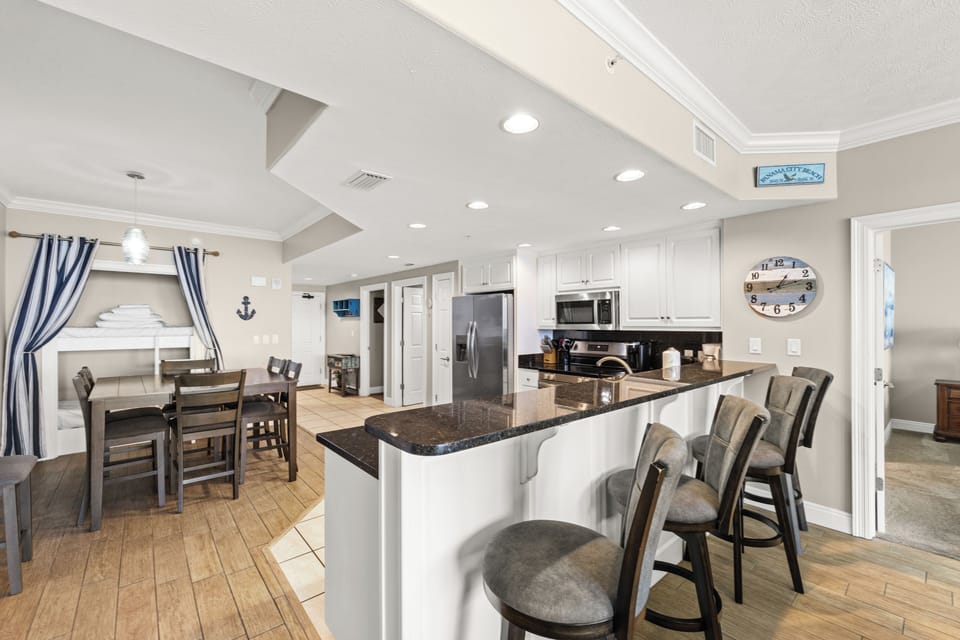 Gather around the spacious kitchen island with bar seating for casual meals and morning coffee. The open layout flows into the dining area, creating the perfect space for your group to connect.