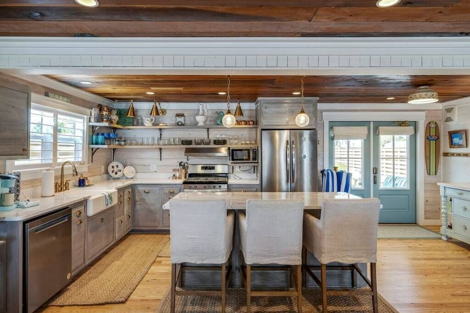 Chef's kitchen fully stocked with cookware and dishware.
