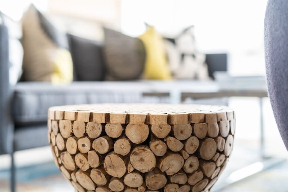 The natural wood tones add a touch of rustic charm, complementing the stylish decor and creating a harmonious blend of comfort and elegance.