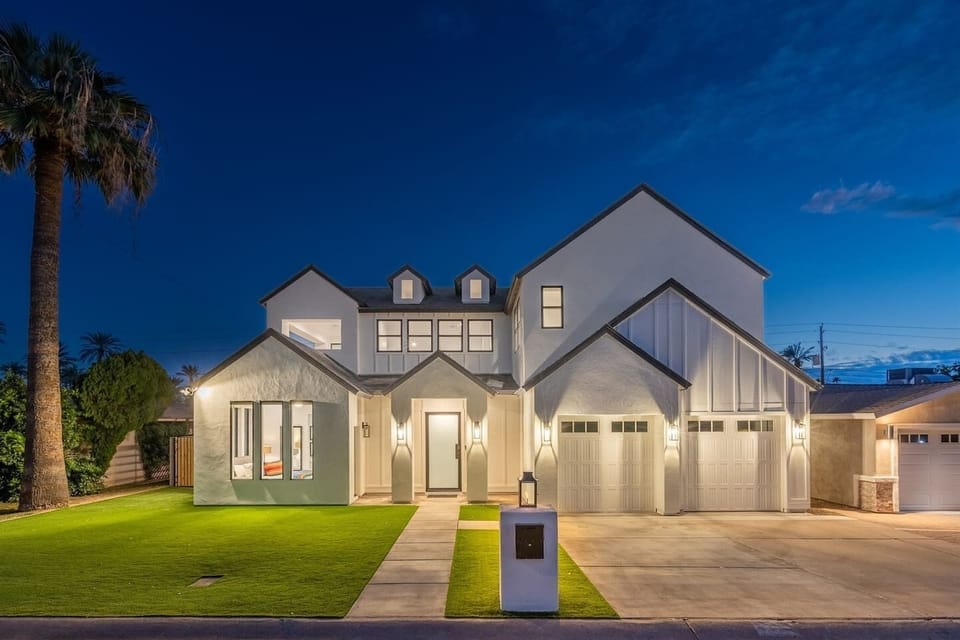 The exterior of the house shines beautifully at night, showcasing its inviting charm and enhancing the warm ambiance of the surrounding area.