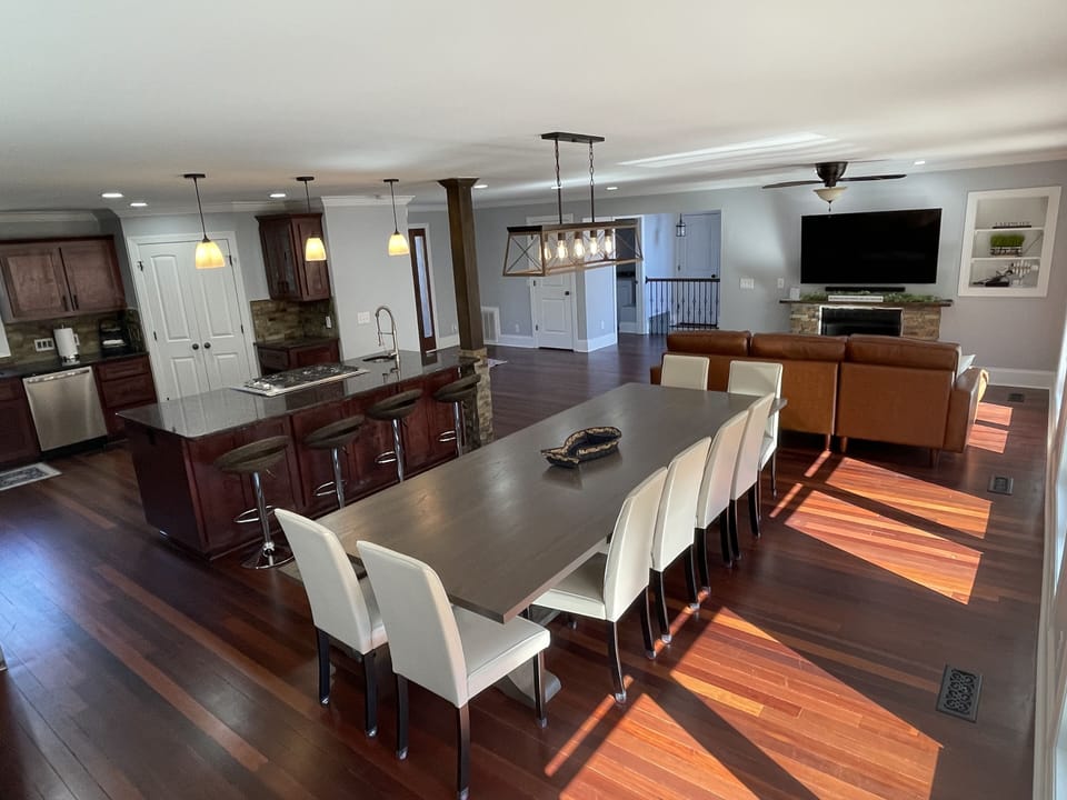 Custom table seating 12+ comfortably in an open kitchen and sitting area 