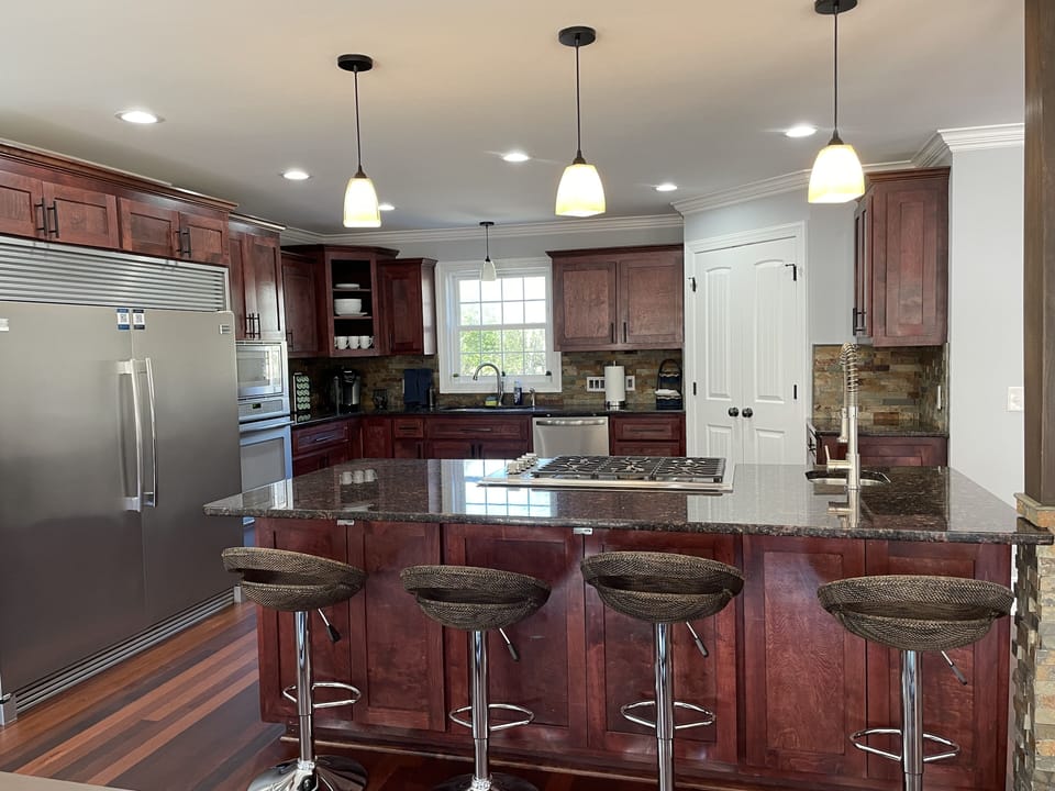 Adjustable height bar stools surrounding the kitchen island 