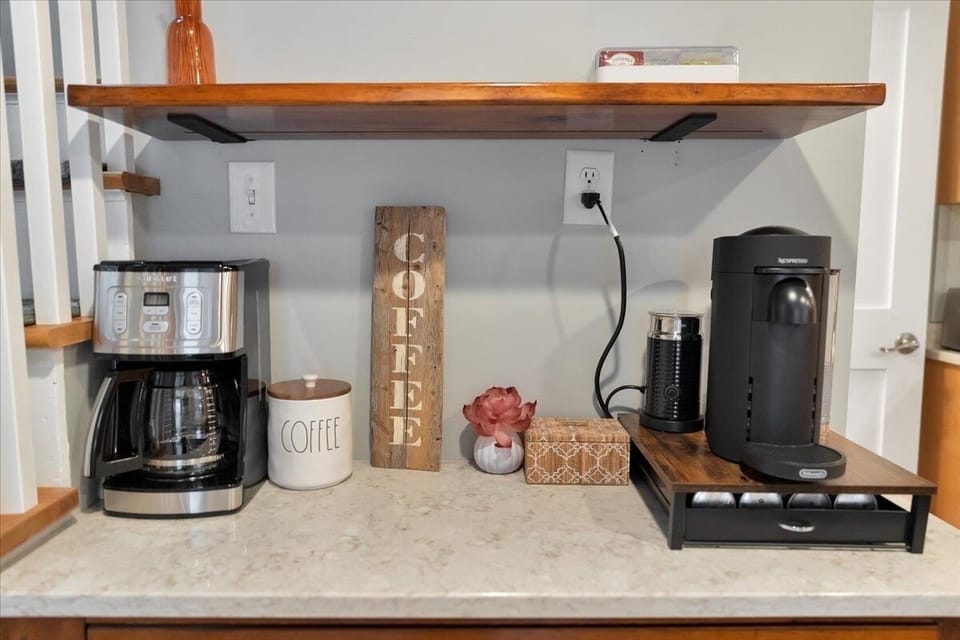 Coffee station with Coffee Pot, Nespresso pods, starbucks syrups and tea.