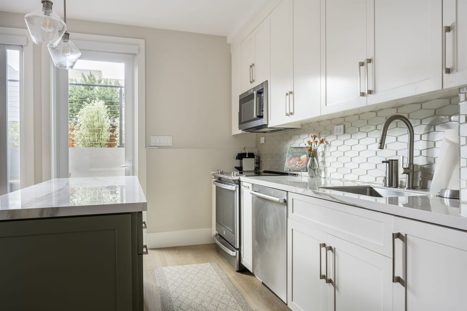 Fully-equipped kitchen with brand new stainless appliances - electric range, microwave, french door refrigerator w/ filtered water, dishwasher, drip & Nespresso coffee makers, toaster, pots + cooking staples (spices + oils, etc.)