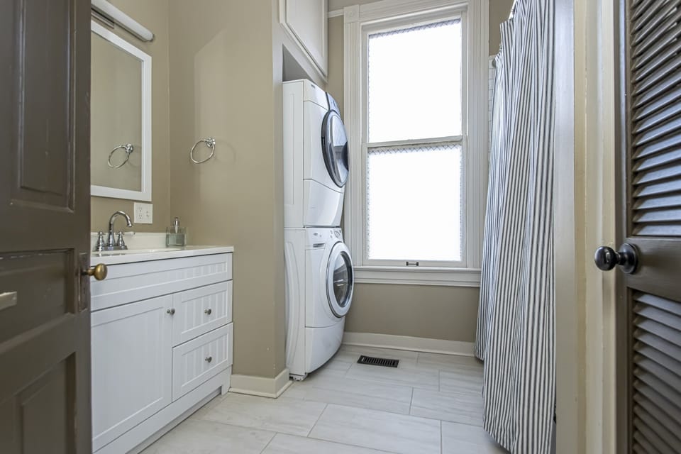 Full size washer and dryer in hall bath.