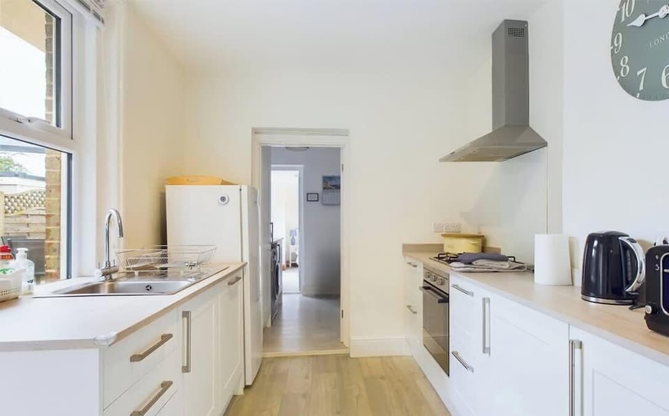 Detail shot of kitchen appliances including oven, dishwasher and coffee station at East View — perfect for self-catering holidays.
