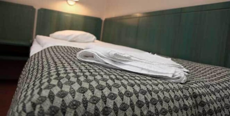 Twin Room | Desk, blackout drapes, iron/ironing board (on request), WiFi (free)