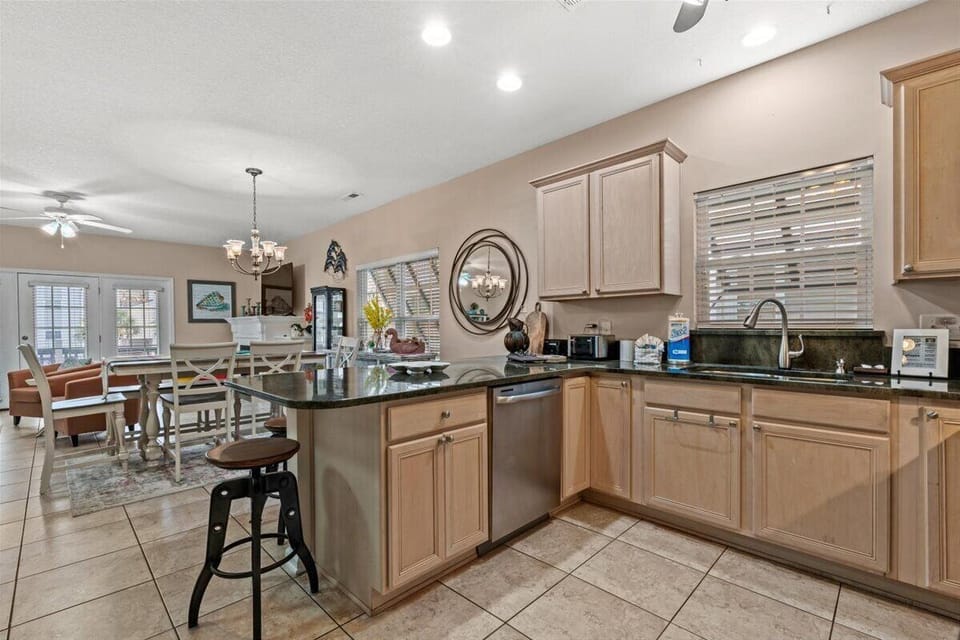 Your spacious kitchen invites culinary adventures with granite counters, stainless appliances, and an island perfect for morning coffee or evening conversations.