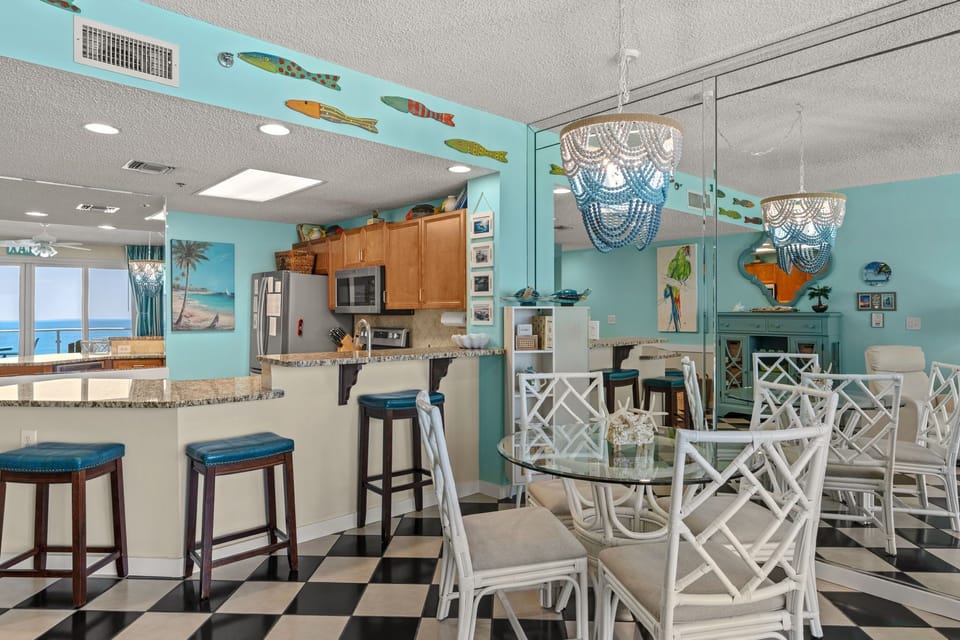 Relax at the breakfast bar or gather around the glass table—perfect for your coastal getaway.