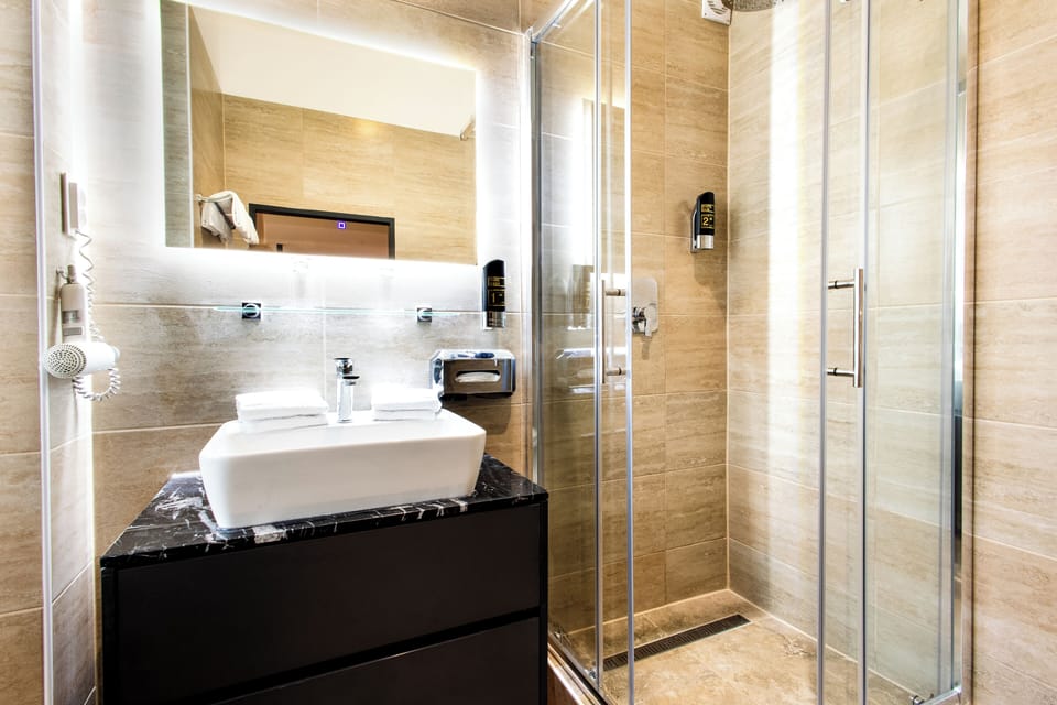 Shower, rainfall showerhead, hair dryer, towels