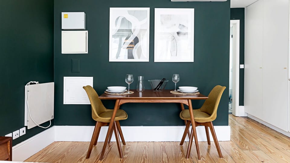Enjoy intimate meals or a morning coffee at this cozy dining nook, beautifully set against a rich emerald wall. This inviting space is perfect for quiet conversations and memorable moments during your stay.