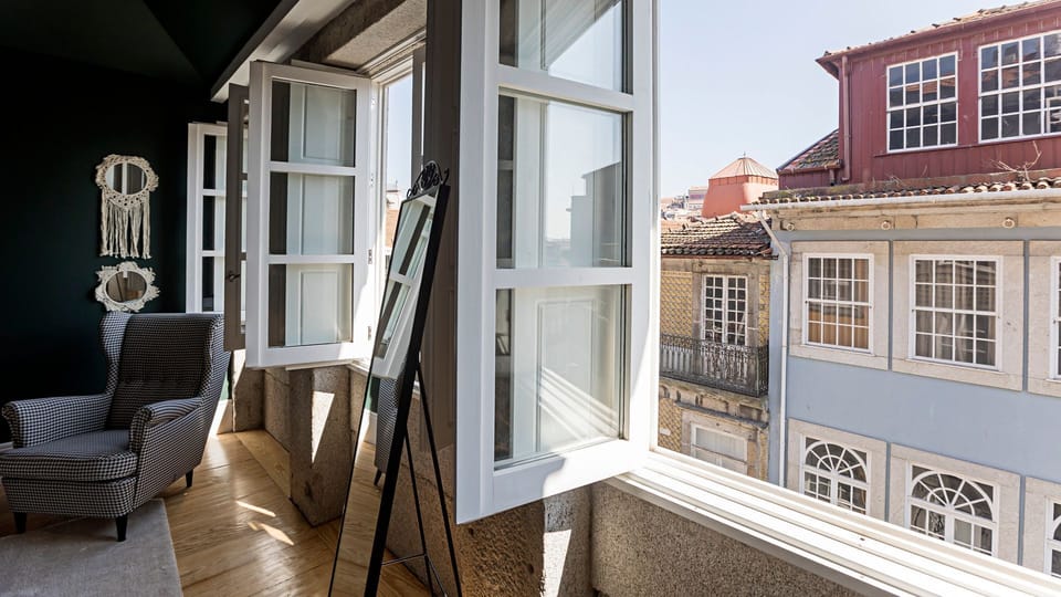 Step onto the charming balcony and soak in the vibrant atmosphere of the historic city, offering picturesque views of classic architecture right outside your window.
