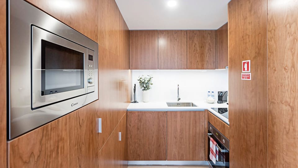 Lovely kitchenette, equipped with all the essentials to make the most out of your trip, like a microwave, stove and oven, coffee machine, and more #modern #stunning